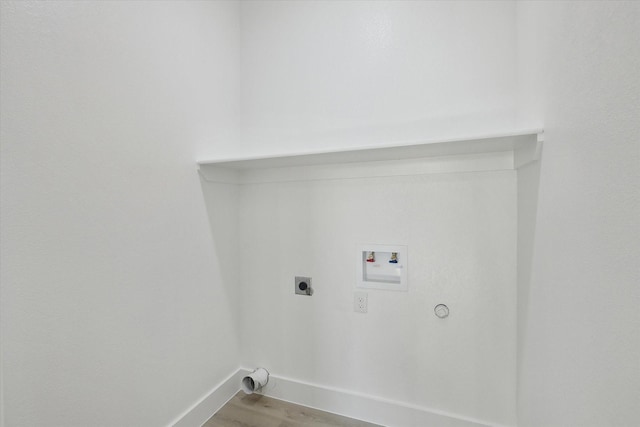 laundry room featuring hookup for a gas dryer, light hardwood / wood-style floors, hookup for a washing machine, and electric dryer hookup