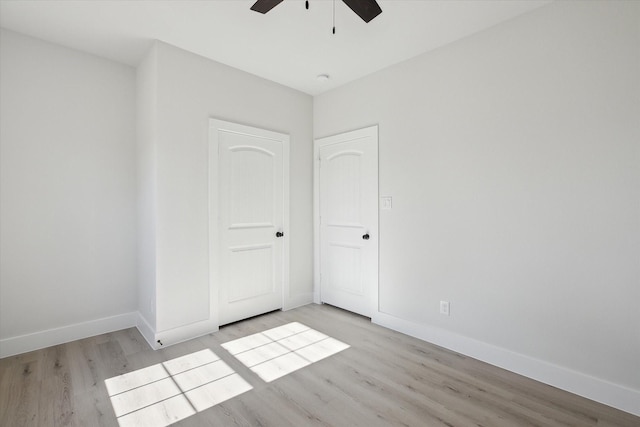 unfurnished bedroom featuring ceiling fan, a closet, and light hardwood / wood-style floors