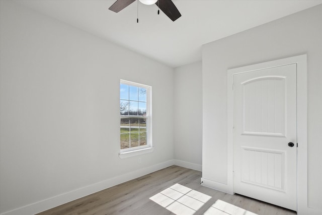 spare room featuring light wood-type flooring and ceiling fan