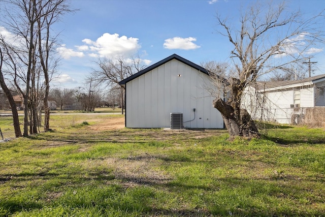 view of home's exterior featuring a lawn and central AC