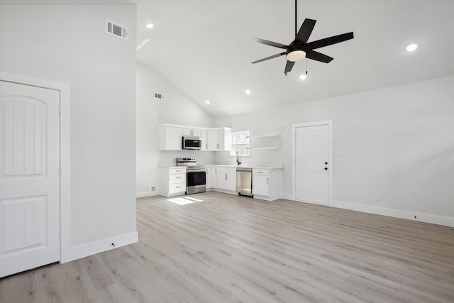 unfurnished living room with ceiling fan, high vaulted ceiling, visible vents, baseboards, and light wood-style floors