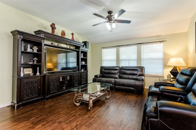 living room featuring ceiling fan, dark wood-type flooring, and lofted ceiling