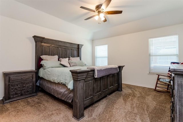 carpeted bedroom with ceiling fan and multiple windows