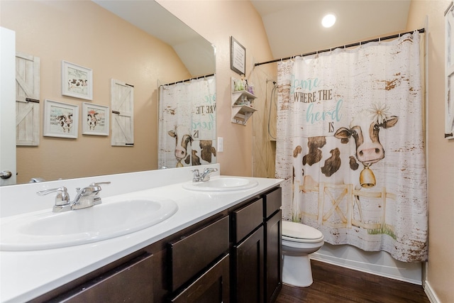 full bathroom featuring toilet, vanity, vaulted ceiling, wood-type flooring, and shower / bath combination with curtain