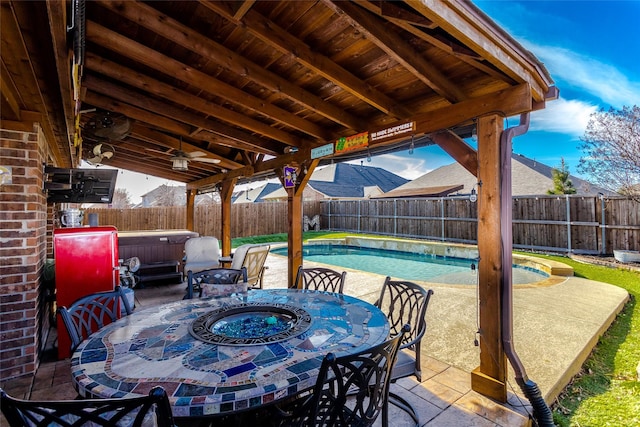 view of patio featuring a swimming pool with hot tub