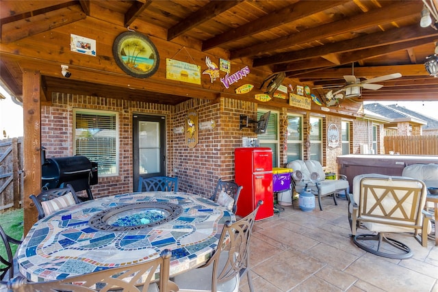 view of patio / terrace featuring ceiling fan, a hot tub, and grilling area