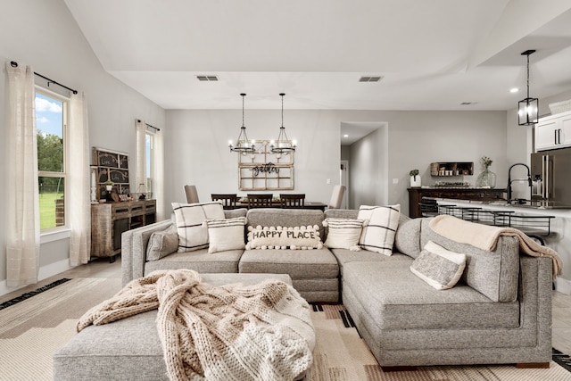 tiled living room featuring sink and vaulted ceiling