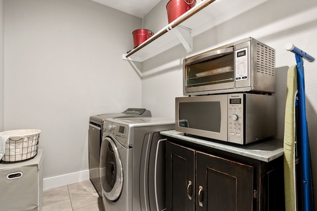 washroom with light tile patterned flooring and washing machine and clothes dryer