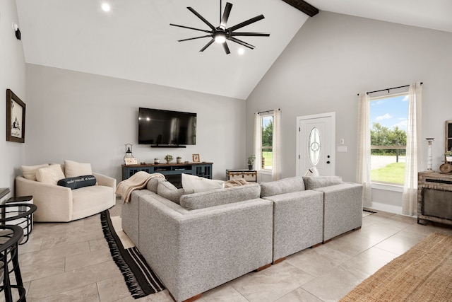 living room with beam ceiling, ceiling fan, and high vaulted ceiling