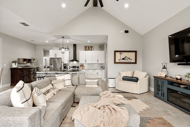 living room featuring ceiling fan and high vaulted ceiling