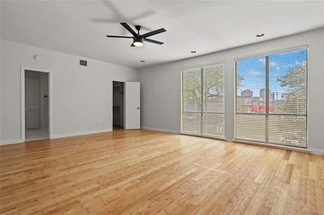 interior space featuring a healthy amount of sunlight, ceiling fan, and wood-type flooring