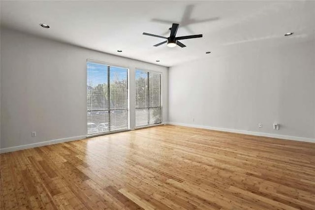 spare room featuring ceiling fan and hardwood / wood-style floors