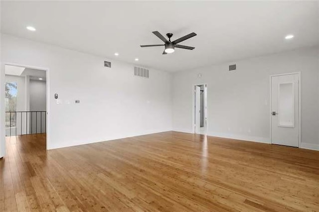 spare room featuring wood-type flooring and ceiling fan