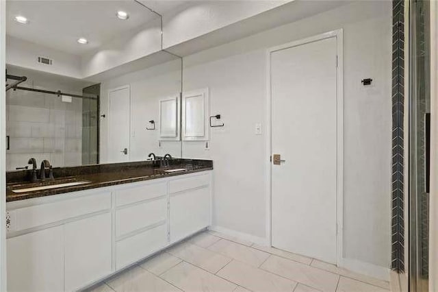 bathroom with vanity, tile patterned flooring, and a shower with shower door