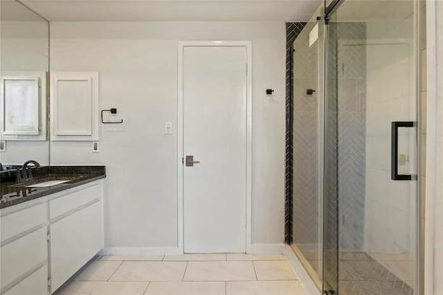 bathroom featuring vanity, tile patterned flooring, and a shower with shower door