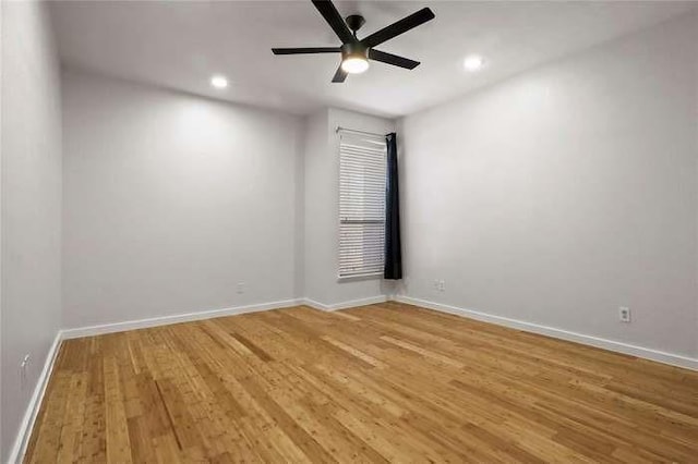 spare room with ceiling fan and hardwood / wood-style floors