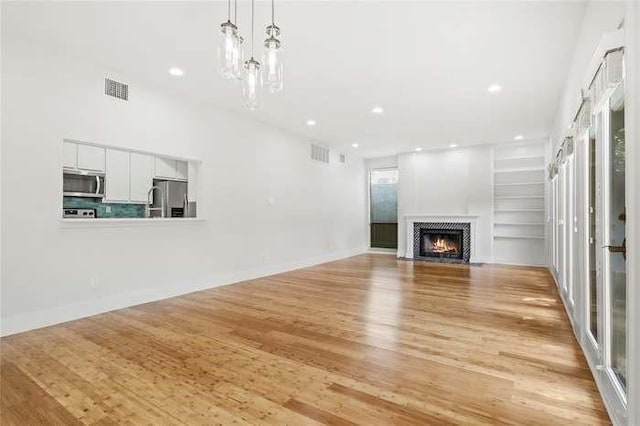 unfurnished living room featuring light hardwood / wood-style flooring