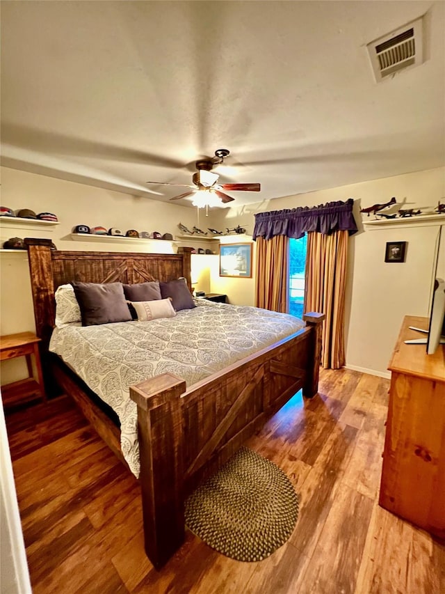 bedroom featuring ceiling fan and hardwood / wood-style floors