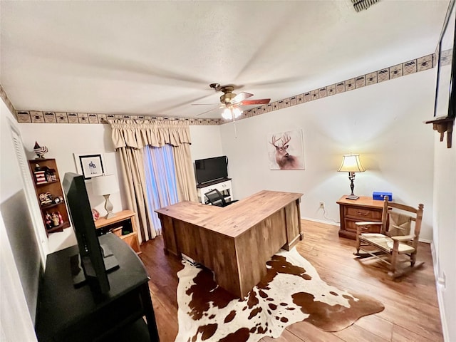 office with ceiling fan and hardwood / wood-style floors