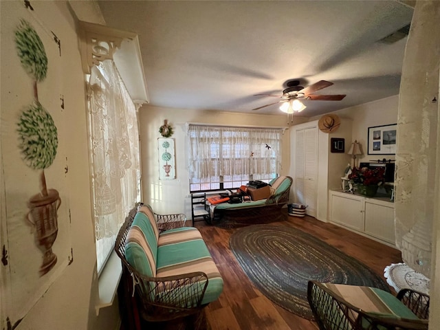 sitting room with dark hardwood / wood-style flooring and ceiling fan