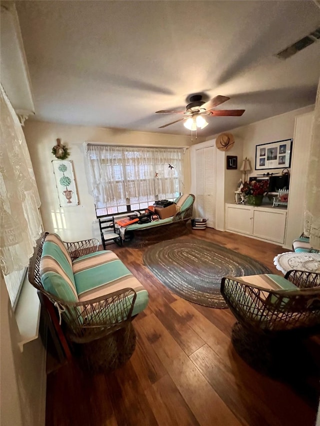 sitting room with ceiling fan and hardwood / wood-style flooring