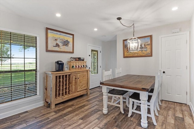 dining room featuring dark hardwood / wood-style flooring and a chandelier