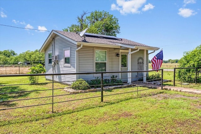 view of front facade featuring a front yard and solar panels