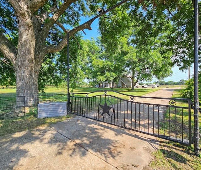 view of gate featuring a yard