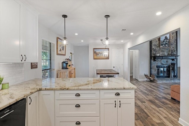 kitchen featuring pendant lighting, white cabinets, dishwasher, backsplash, and hardwood / wood-style flooring