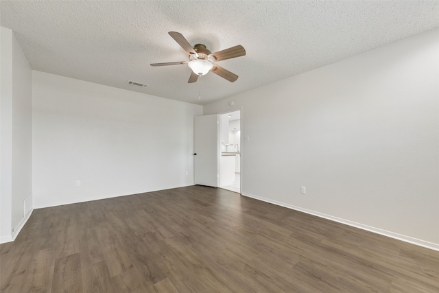 unfurnished room with ceiling fan, dark hardwood / wood-style floors, and a textured ceiling