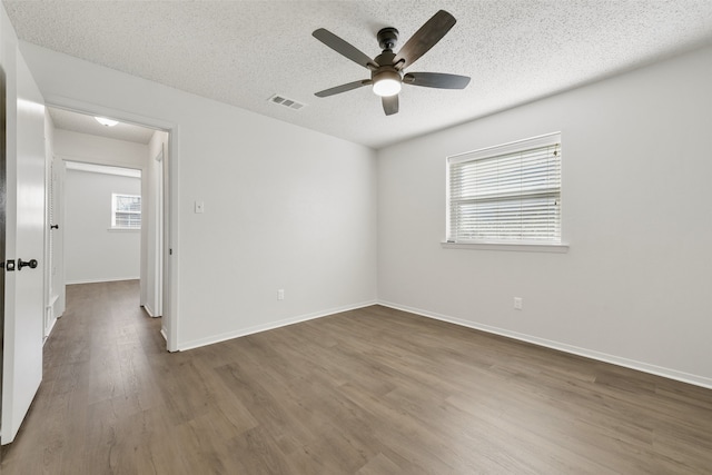 unfurnished room featuring a textured ceiling, ceiling fan, and hardwood / wood-style flooring