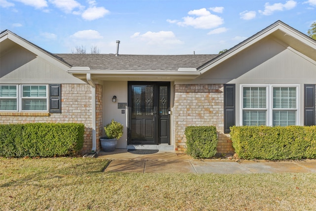 doorway to property with a yard