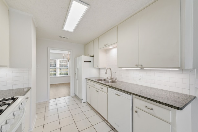 kitchen featuring white appliances and white cabinetry