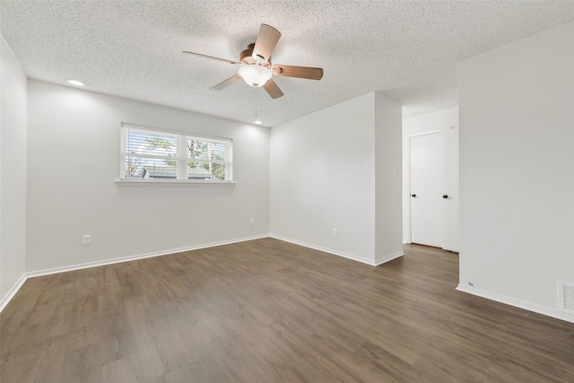 unfurnished room featuring a textured ceiling and dark hardwood / wood-style flooring