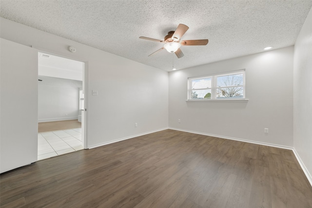 spare room with light hardwood / wood-style floors, a textured ceiling, and ceiling fan