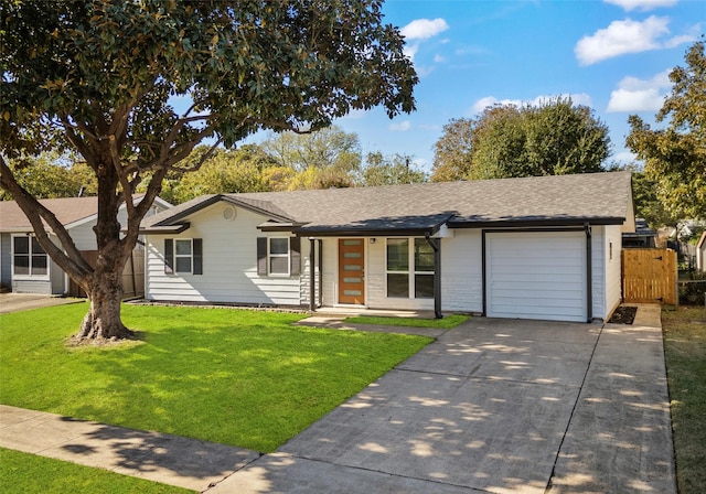 ranch-style house featuring a front yard and a garage