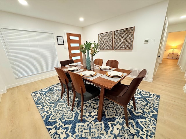 dining space with light wood finished floors, baseboards, and recessed lighting