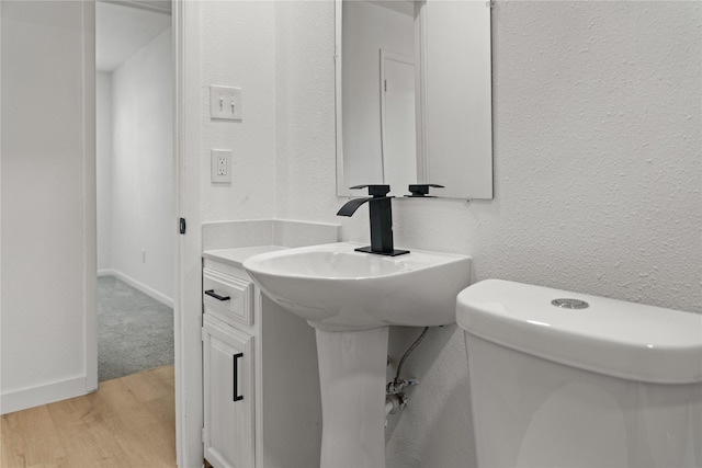 bathroom featuring hardwood / wood-style floors and toilet