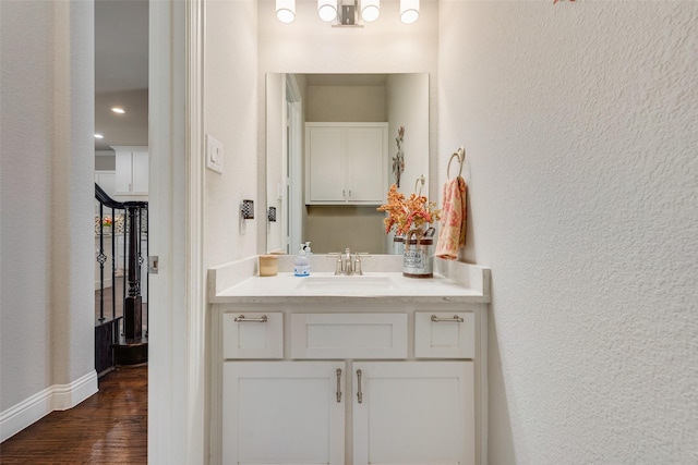 bathroom with hardwood / wood-style floors and vanity