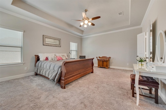 carpeted bedroom with a raised ceiling, ceiling fan, and crown molding