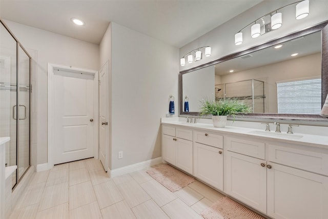 bathroom with a shower with door and vanity