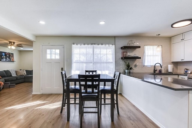 dining area featuring sink, ceiling fan, and light hardwood / wood-style floors