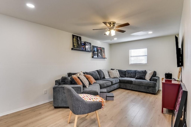 living room featuring ceiling fan and light hardwood / wood-style floors