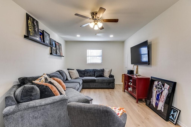 living room featuring ceiling fan and light hardwood / wood-style floors