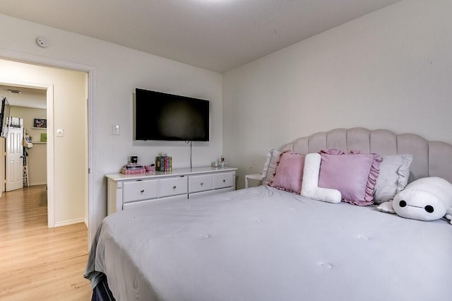 bedroom with light hardwood / wood-style floors