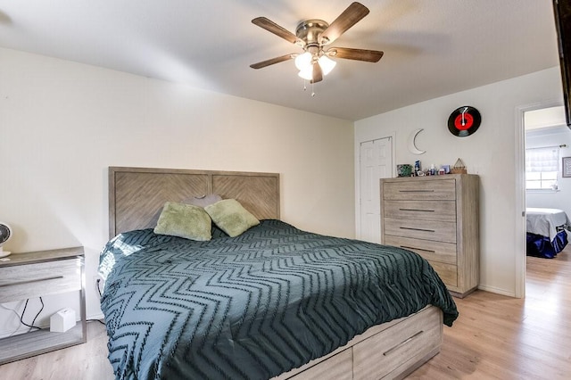 bedroom featuring light wood-type flooring and ceiling fan