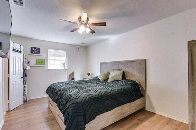 bedroom featuring ceiling fan and light hardwood / wood-style flooring