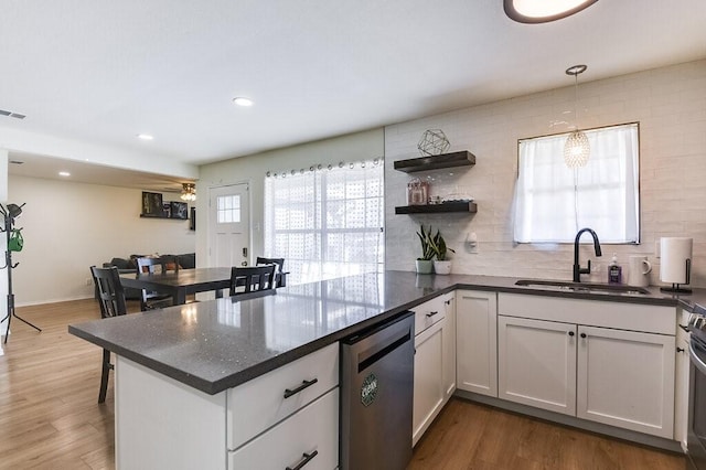 kitchen with white cabinets, appliances with stainless steel finishes, tasteful backsplash, and sink