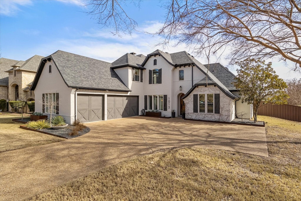 view of front of property with a front yard and a garage