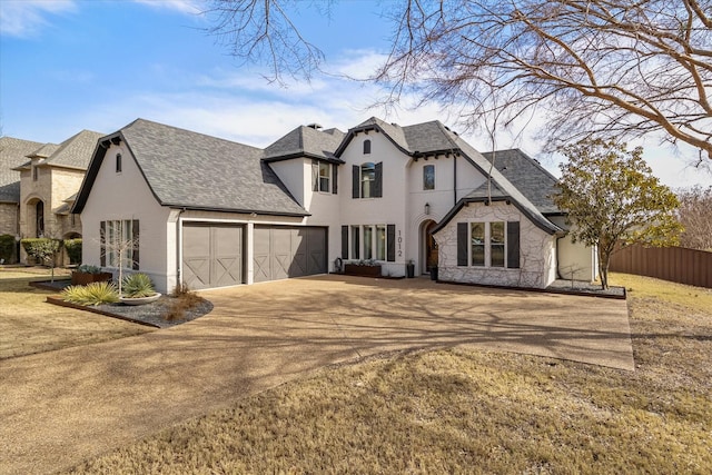 view of front of property with a front yard and a garage